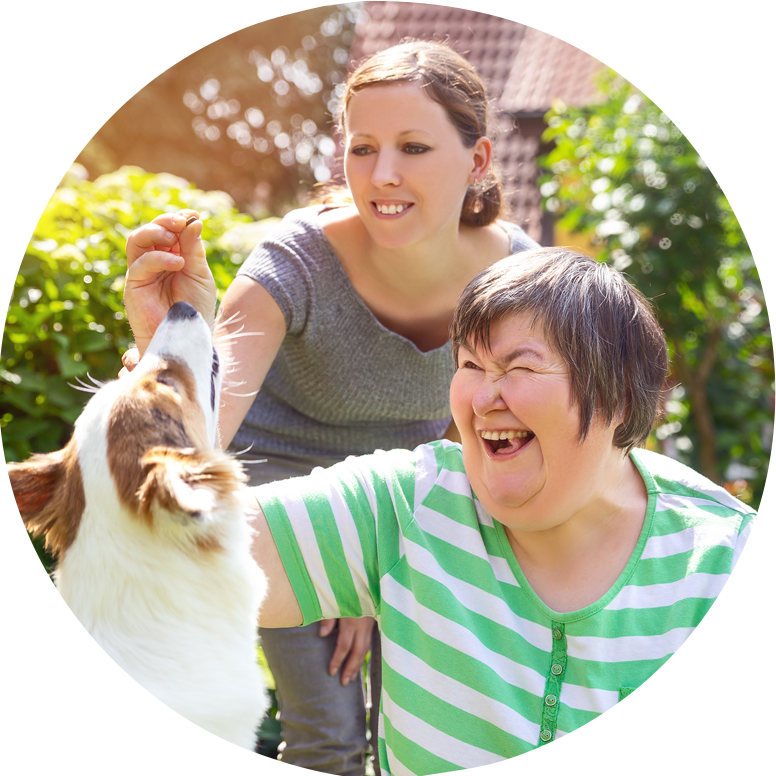 two ladies with dog smiling