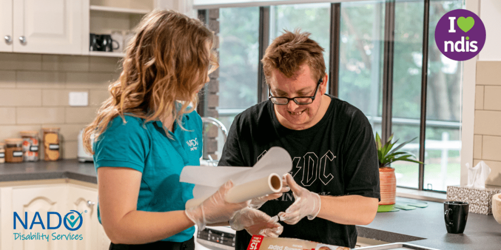 Female Support Worker helping male NDIS Participant in kitchen